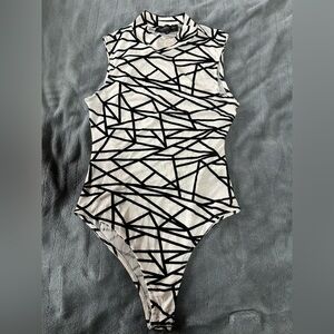 Stunning asymmetrical print body suit. Sz Large. Never worn.